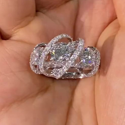 Jorrio handmade round cut triple-stone crisscross pavé halo moissanite ring